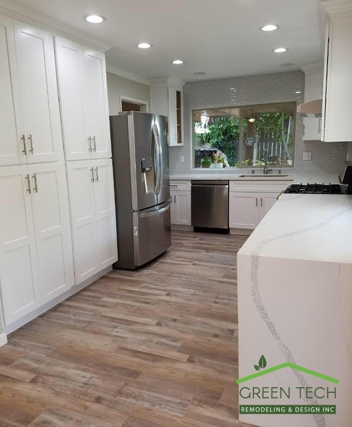 Remodeled kitchen with white shaker cabinets and stainless steel appliances